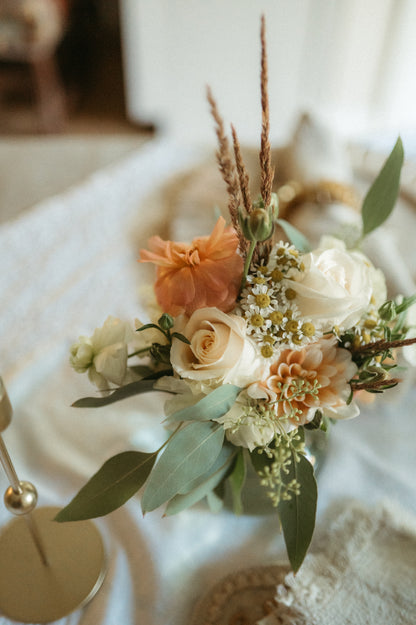 Floral arrangement with peach and white flowers on a soft background