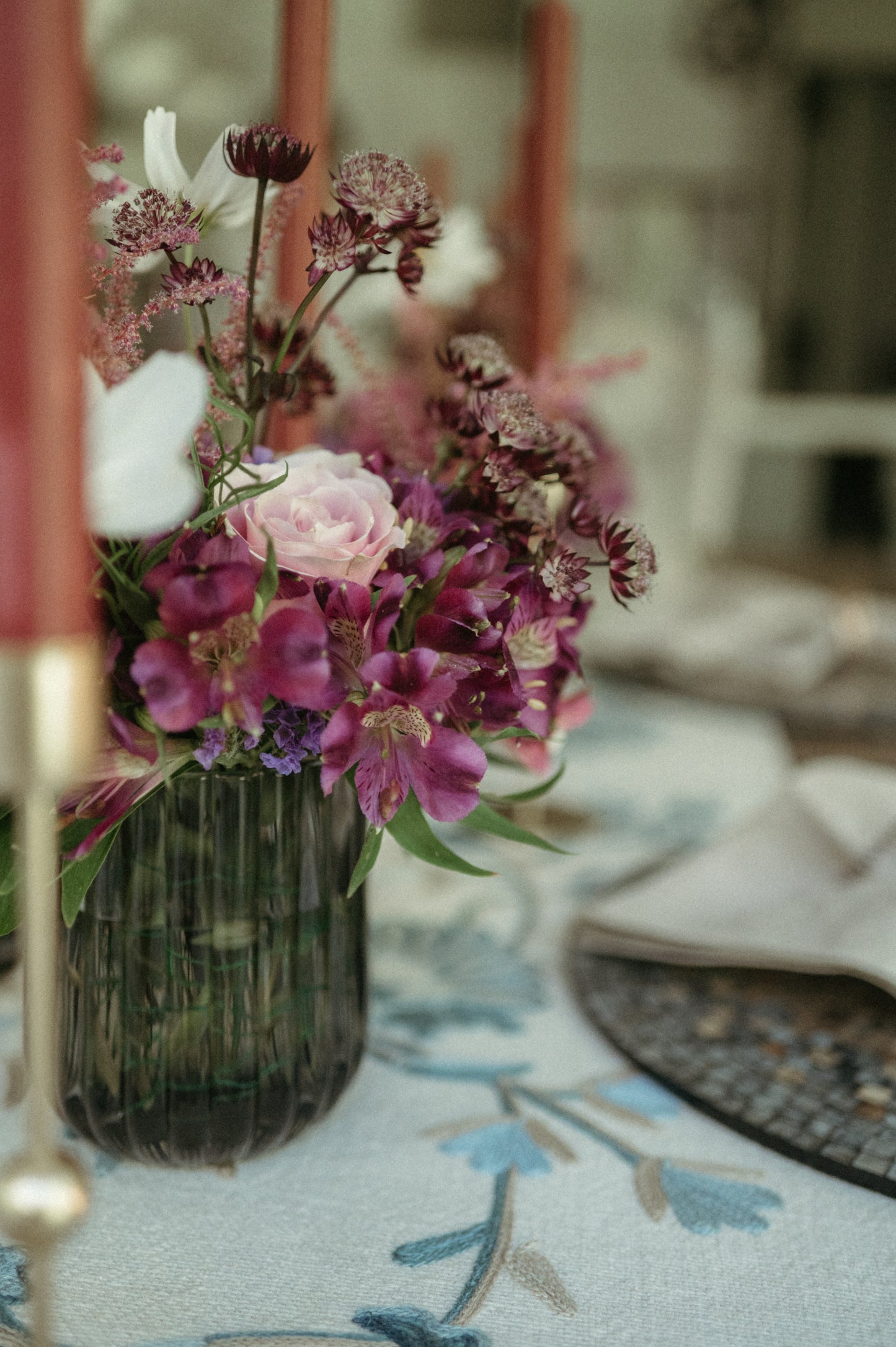Floral arrangement in a vase on a table with a blurred background
