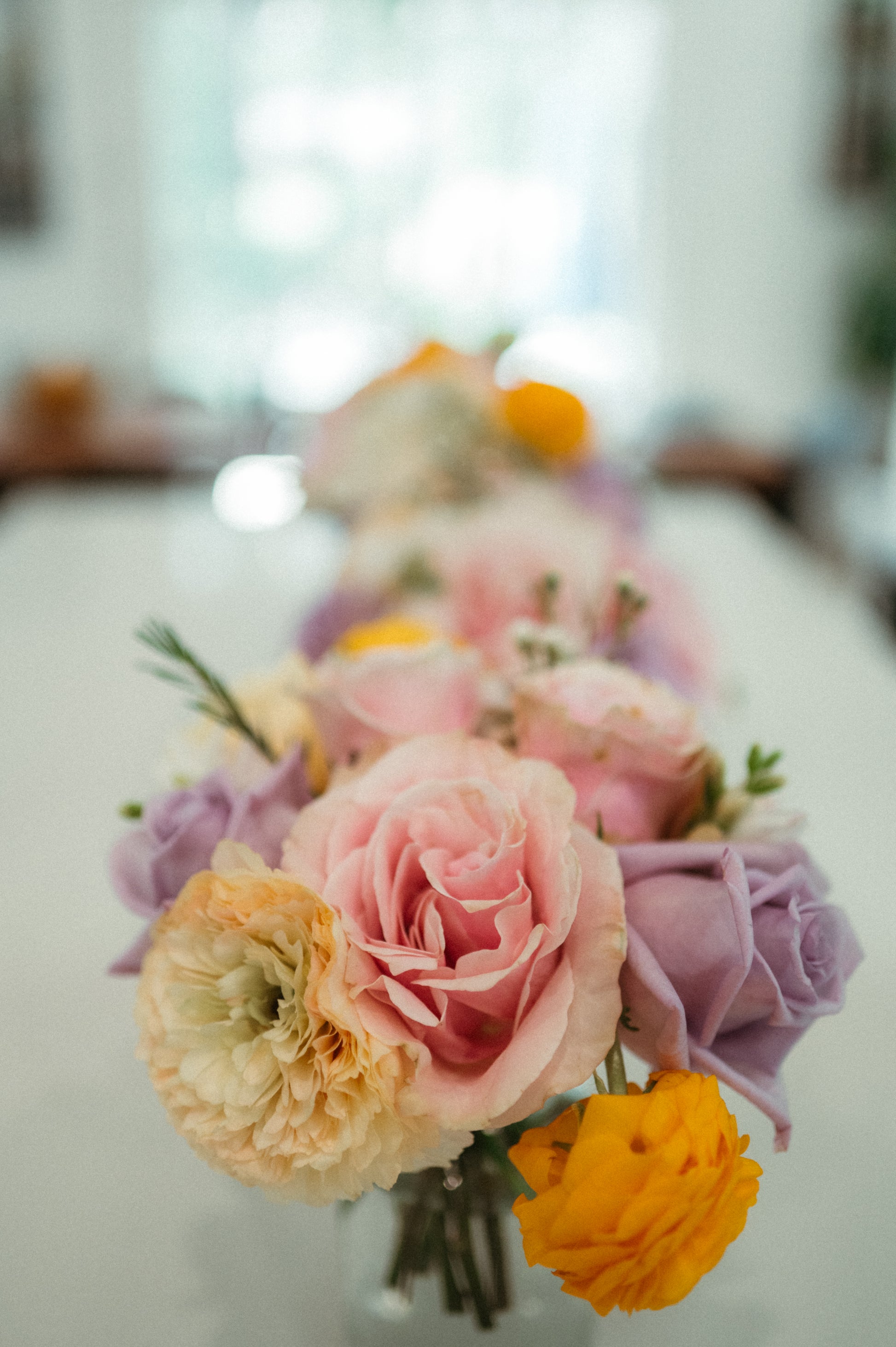 Bouquet of pink, yellow, and purple flowers on a blurred background